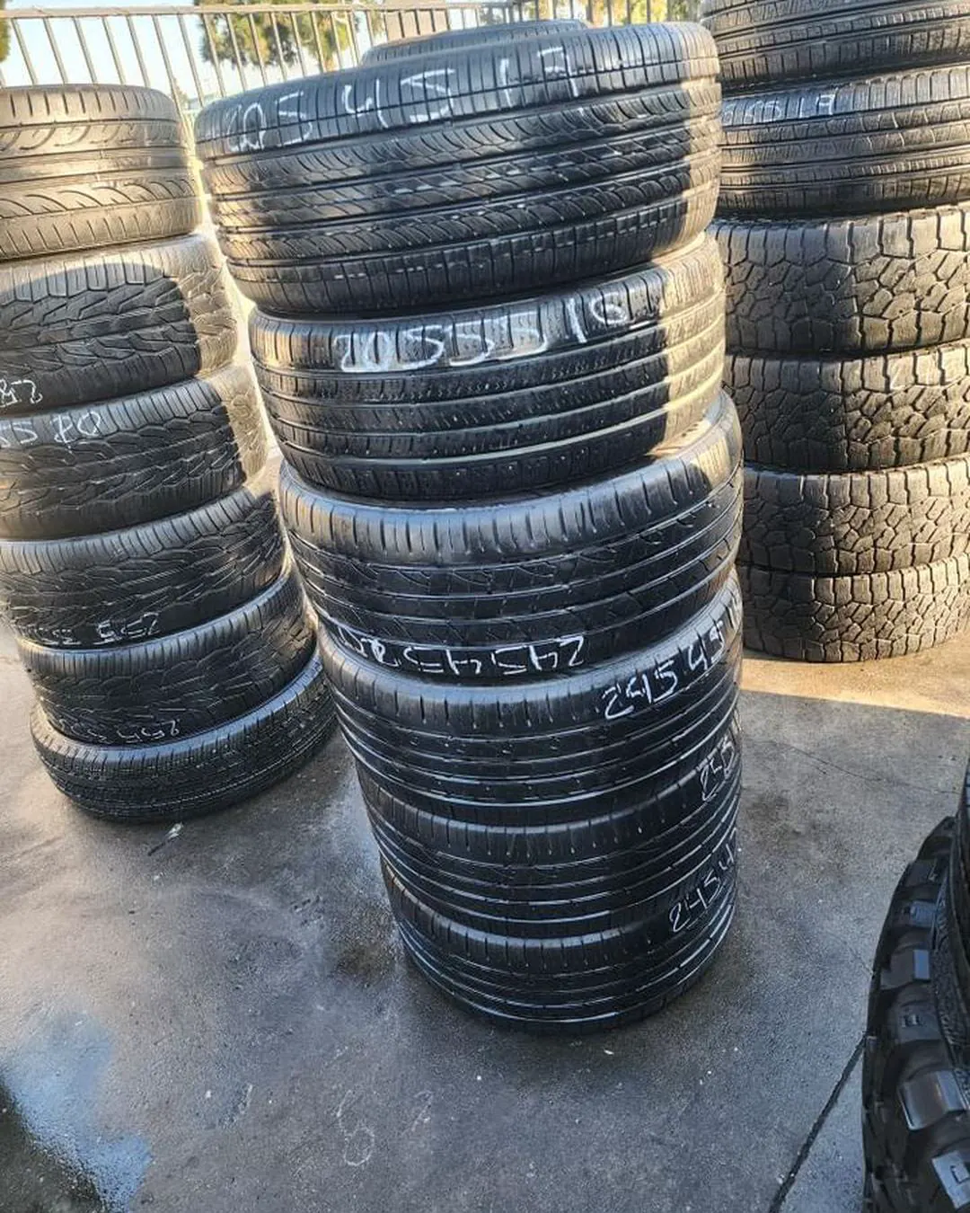 Long aisle of tire stacks captured in warm early light
